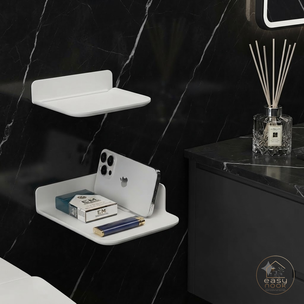 White folding wall shelf holding phone and diffuser in bathroom
