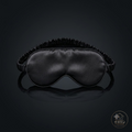 Black 3D contoured sleep mask on dark background