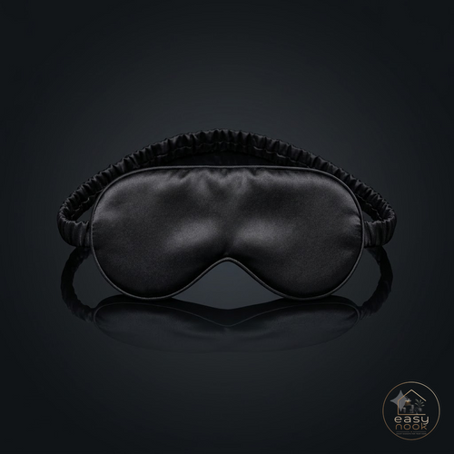 Black 3D contoured sleep mask on dark background